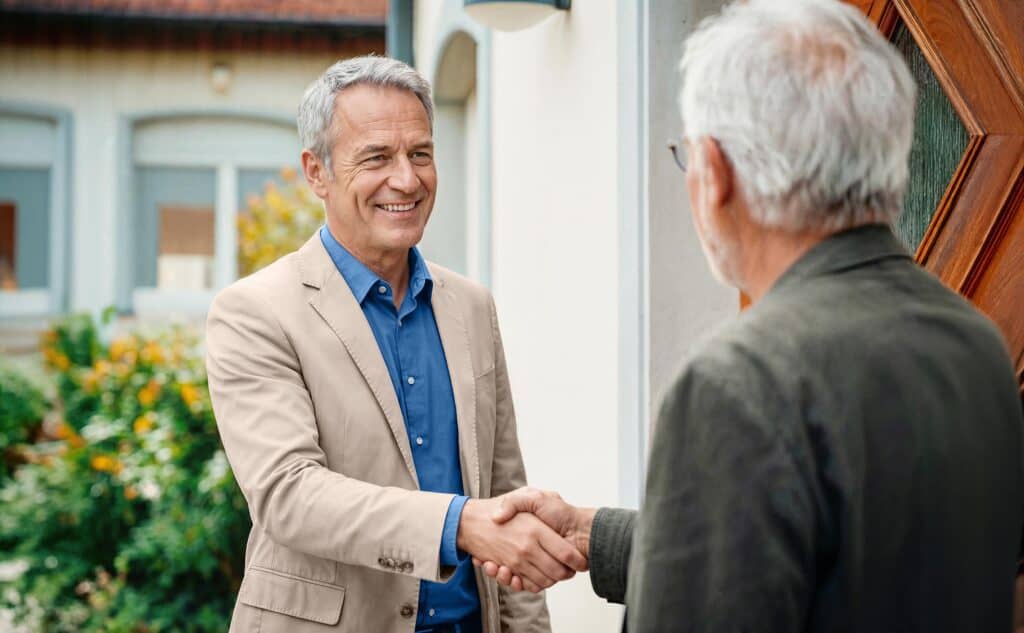 Male Dovida Care Advisor shaking hands with a client